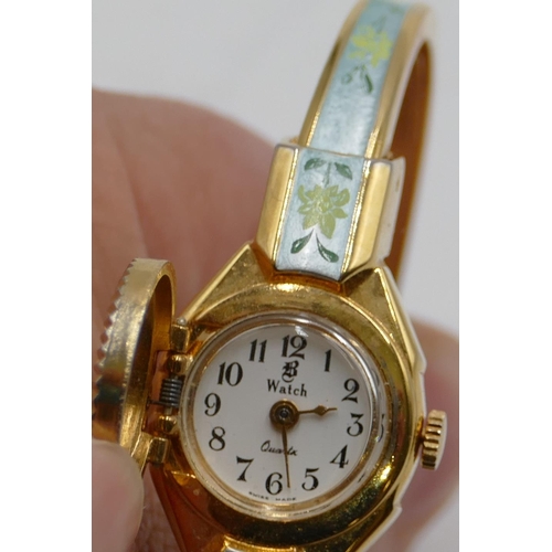 528 - An Andre Mouche gilt metal and enamelled watch with expanding strap, hinged top enclosing dial.