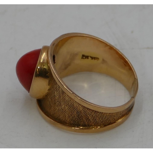 548 - A high carat continental gold ring set with red carbuncle with all over chased decoration, size W. 7... 