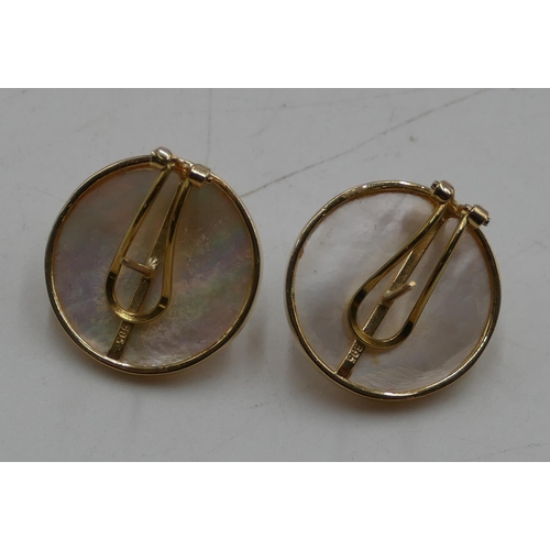 565 - A pair of 14ct gold mother of pearl earrings mounted with small diamonds, 2cm diameter, 8 grams gros... 