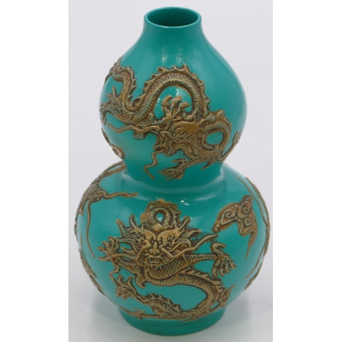 57 - An Oriental double gould vase on green ground with raised gilt dragon decoration, 17cm high.