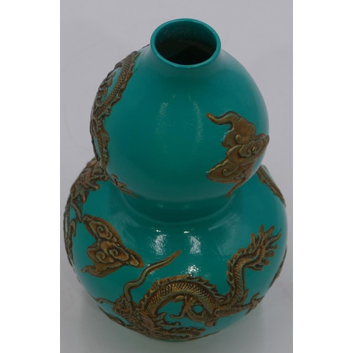 57 - An Oriental double gould vase on green ground with raised gilt dragon decoration, 17cm high.