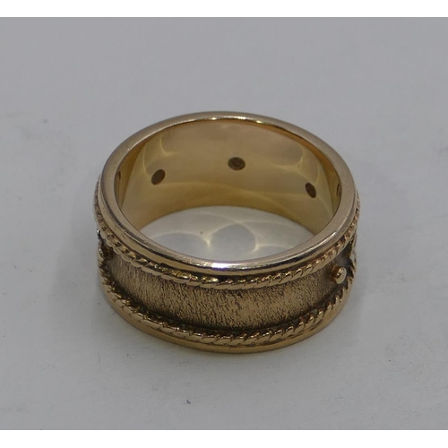 595 - A 9ct gold wide wedding band ring, inset with 5 small diamonds, size O, 7grams gross