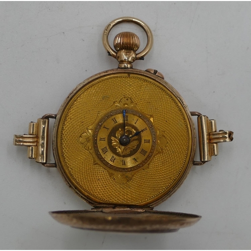 599 - A 9ct gold circular fob watch converted to a wrist watch with overall chased decoration, Roman numer... 