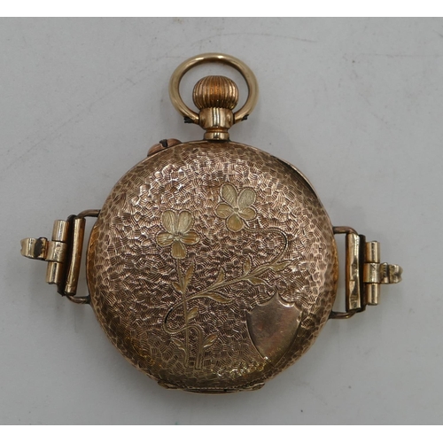 599 - A 9ct gold circular fob watch converted to a wrist watch with overall chased decoration, Roman numer... 