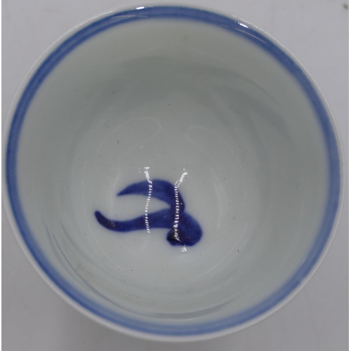 60 - An Oriental round trumpet shaped cup on blue and white ground with dragon decoration, 9cm high.