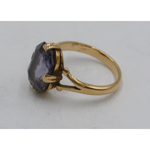 609 - A Continental gold ring set with pale blue stone, open shoulders, size J, 3.8g