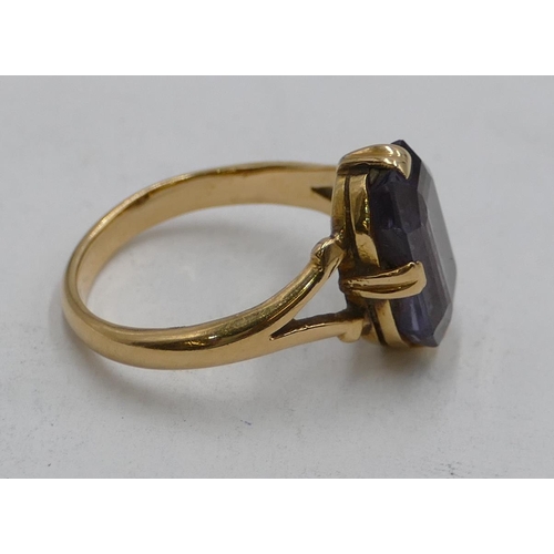 609 - A Continental gold ring set with pale blue stone, open shoulders, size J, 3.8g