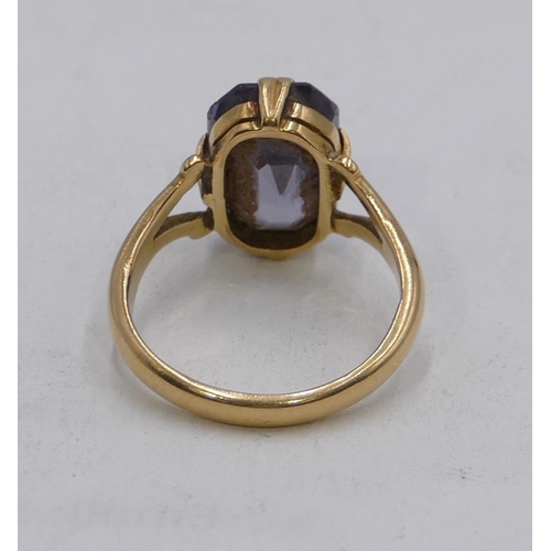 609 - A Continental gold ring set with pale blue stone, open shoulders, size J, 3.8g