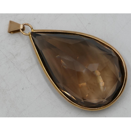 634 - A large gold mounted smoky quartz pear shaped pendant, 6.7cm high