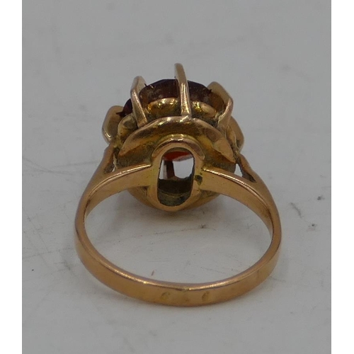 642 - A Continental gold ladies ring set with centre red stone, size K/L, 5.1g