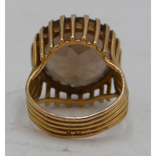 644 - A Continental ladies gold ring set with circular smoky quartz with allover pierced decoration, size ... 