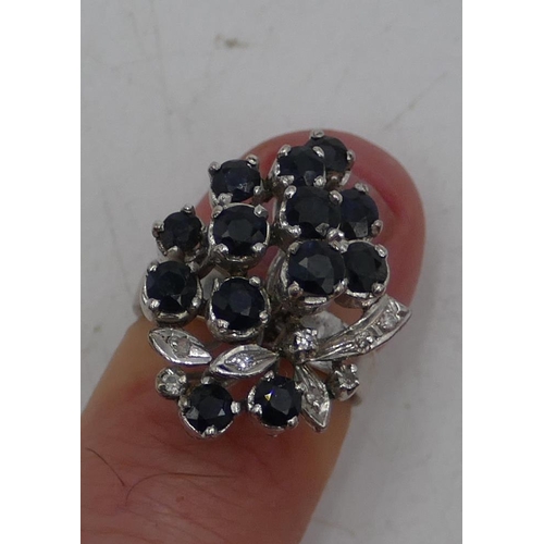 646 - A 18ct white gold ladies spray cluster ring set with various sapphires, interspersed by small diamon... 