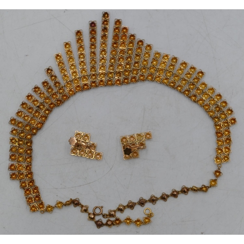 653 - A Continental high carat gold necklace with various length tassels etc, allover studded decoration, ... 