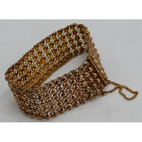 654 - A Continental high carat gold wide band bracelet with raised studded decoration, 18cm long, 33.4g