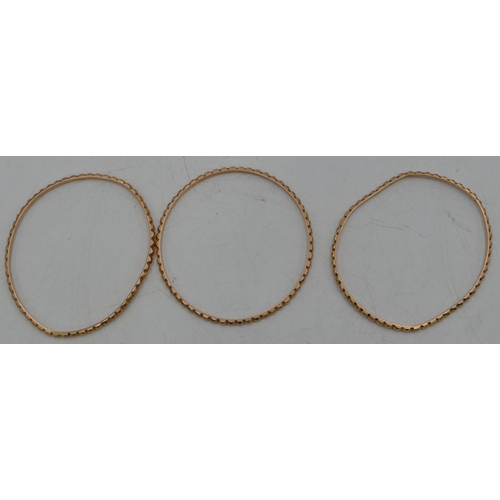 656 - Set of 3 Continental high carat gold bangles with raised studded decoration, 51g