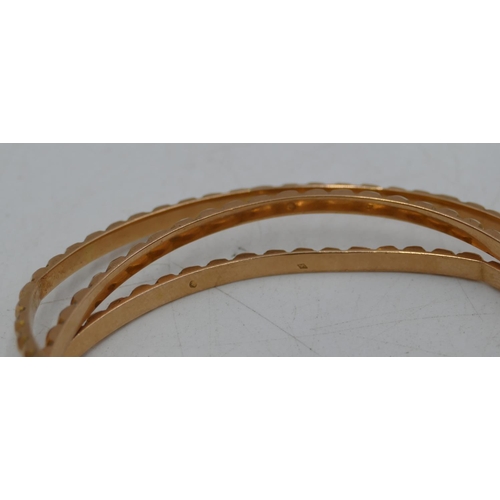 656 - Set of 3 Continental high carat gold bangles with raised studded decoration, 51g