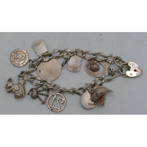 668 - A silver bracelet with padlock clasp, mounted with 10 silver charms.