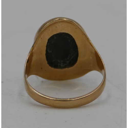 673 - A 9ct gold oval Tigers Eye ring, size P/Q, 5 grams gross.