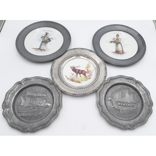 691 - A pair of Continental round pewter and china plates with figure motifs to centres, 26cm diameter, a ... 