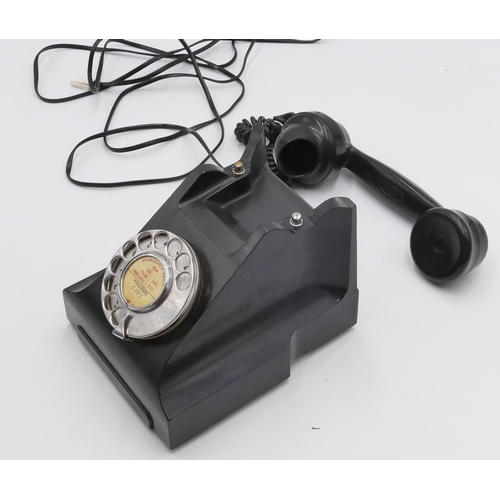 698 - A vintage Bakelite ATM black telephone with chrome dial wheel.