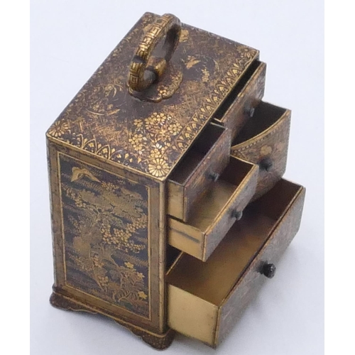 717 - An Oriental metal miniature trinket chest with allover gilt and black river, landscape, building, fl... 