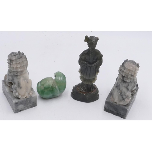 718 - A green hard stone figure of a seal lying on its back, 7.5cm wide, a pair of hard stone figures, dog... 