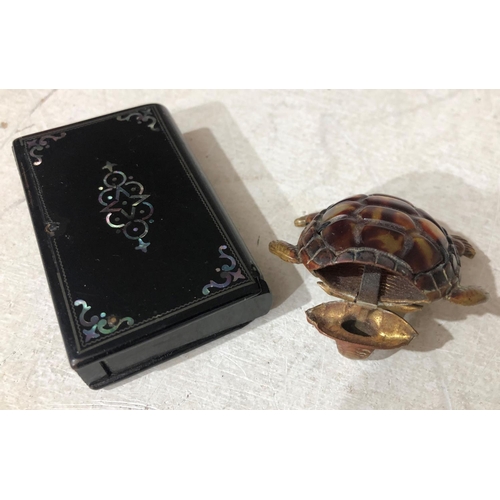 731 - A novelty brass vesta case in the form of a tortoise and a black lacquered vesta case in the form of... 