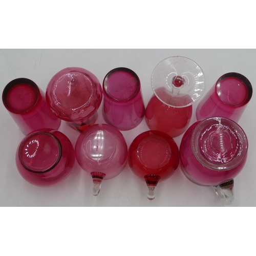 75 - 2 Cranberry glass jugs, 1 vase (small chip to rim) and 6 various Cranberry glasses. (9)