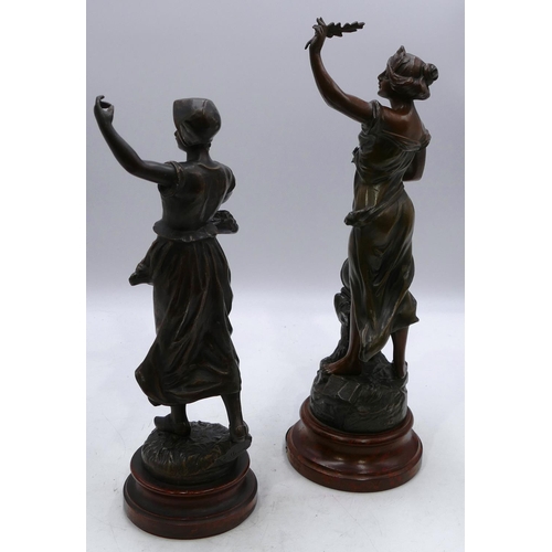 754 - A spelter figure of a standing lady 