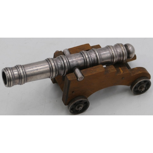 755 - A silvered metal table top cannon with wooden carriage, 19.5cm long