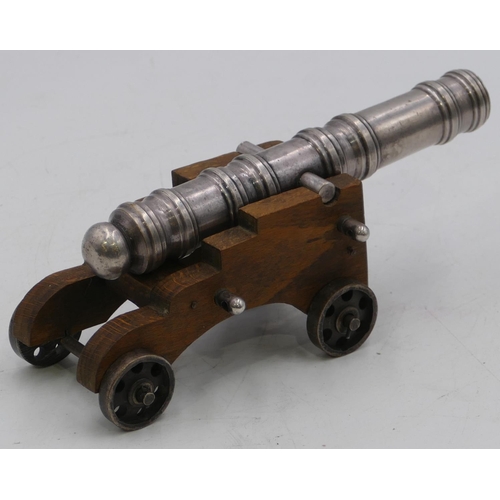 755 - A silvered metal table top cannon with wooden carriage, 19.5cm long