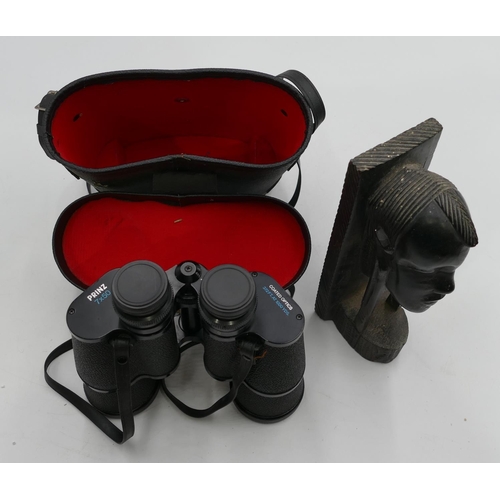 757 - A pair of Prinz 7 x50 binoculars and a carved African figurehead. (2)