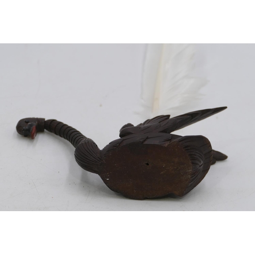 762 - A Black Forest carved pen holder in the form of a swan with articulated neck and feather quill. (2)