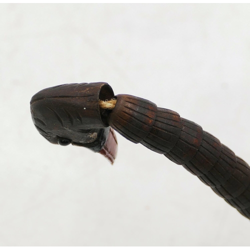 762 - A Black Forest carved pen holder in the form of a swan with articulated neck and feather quill. (2)