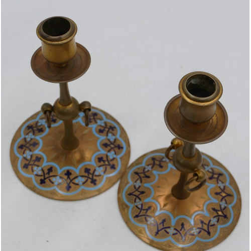 763 - A pair of French gilt metal candlesticks with turned stems, inlaid with turquoise blue enamel, on ro... 