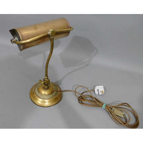 776 - An early brass desk lamp with revolving shade, on round sweeping base, 40cm high.