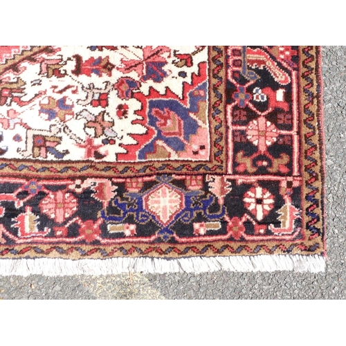 780 - A Heriz rug on red and blue ground with centre medallion, 2 meters 10 x 1 meter 56cm.