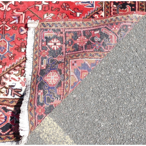 780 - A Heriz rug on red and blue ground with centre medallion, 2 meters 10 x 1 meter 56cm.