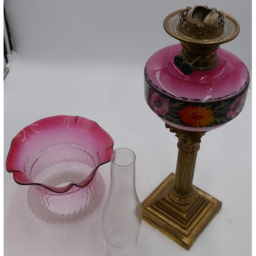 796 - A brass Corinthian paraffin lamp with pink glass bowl and painted floral and leaf decoration with fu... 