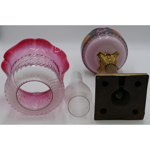 796 - A brass Corinthian paraffin lamp with pink glass bowl and painted floral and leaf decoration with fu... 