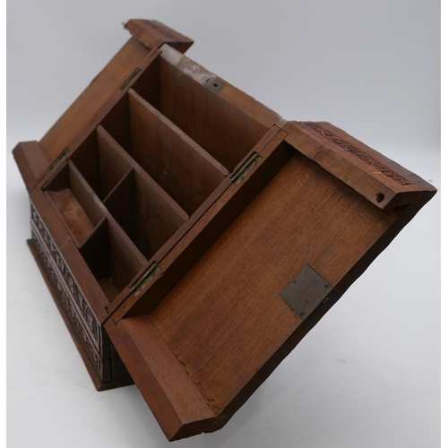 797 - A carved wooden stationery box with sloping double hinged front with raised leaf and scroll decorati... 