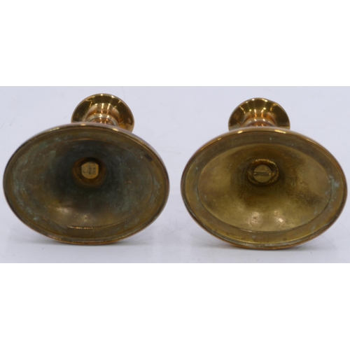 806 - A pair of brass candlesticks on turn stems with oval sweeping bases, 15.5cm high