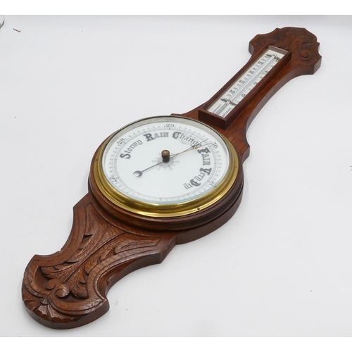 830 - An oak hanging banjo barometer with thermometer, carved scroll decoration, 81cm high.