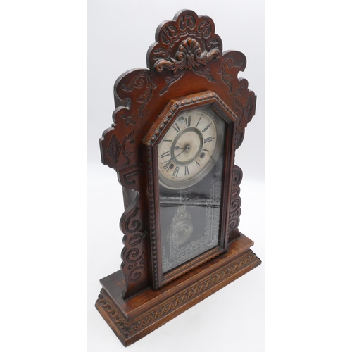 834 - An American Ansonia mantle clock with allover carved decoration, glass door enclosing cream dial wit... 