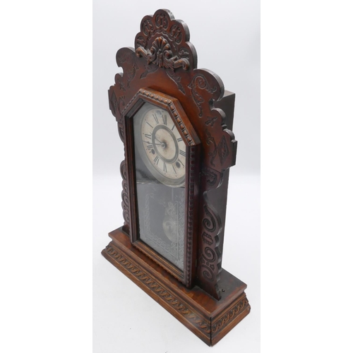 834 - An American Ansonia mantle clock with allover carved decoration, glass door enclosing cream dial wit... 