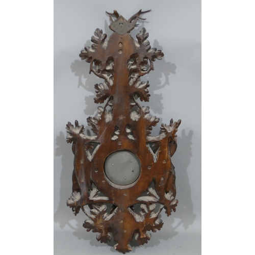 852 - A 19th Century Black Forest carved barometer and thermometer with raised deer motif, dogs head, rabb... 