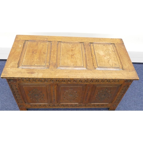 856 - An early 20th Century dower chest with triple panelled hinged top, carved triple panelled front and ... 