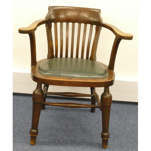 857 - A 1930's oak tub desk chair with stick back, green leather overstuffed seat and on round turned legs... 