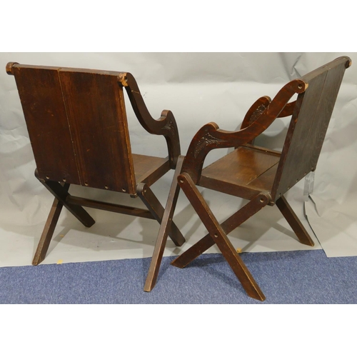 864 - A pair of oak Bishop's chairs with solid seats, carved panelled backs with floral, leaf and scroll d... 