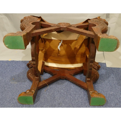 869 - A 19th Century large heavily carved oak stool with concave leather seat (leather in need of restorat... 